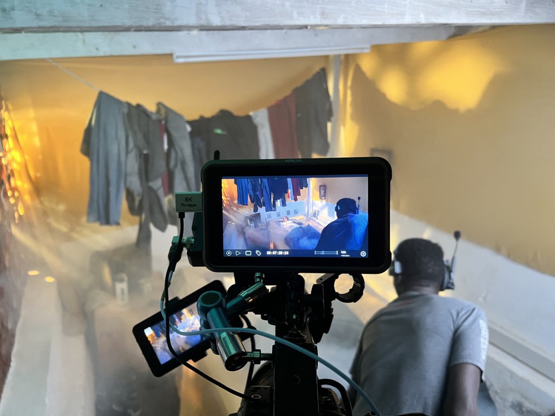 Operator shooting down a smoke-filled corridor hung with laundry